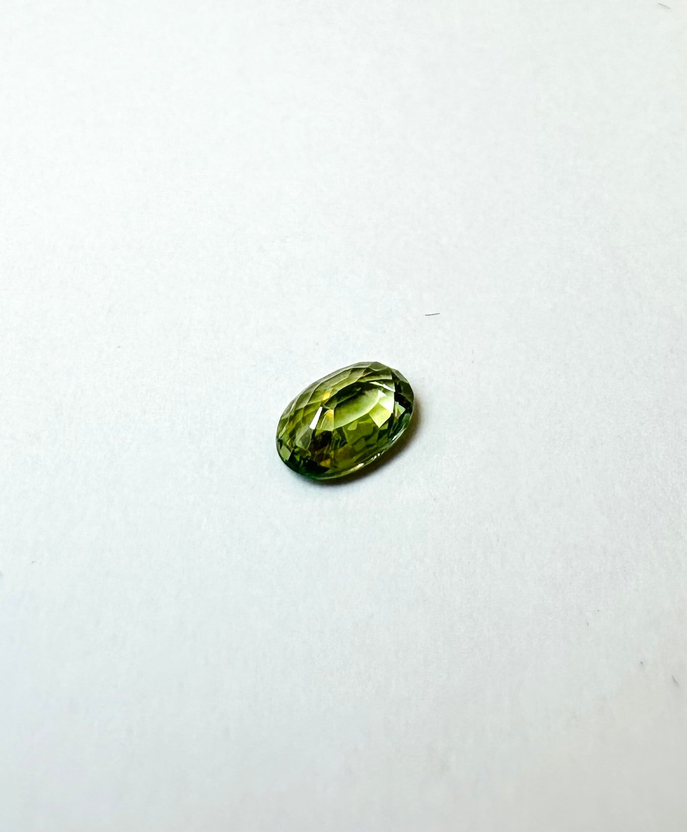 0.65cts 6.08x4.25mm Oval Faceted Green Sapphire