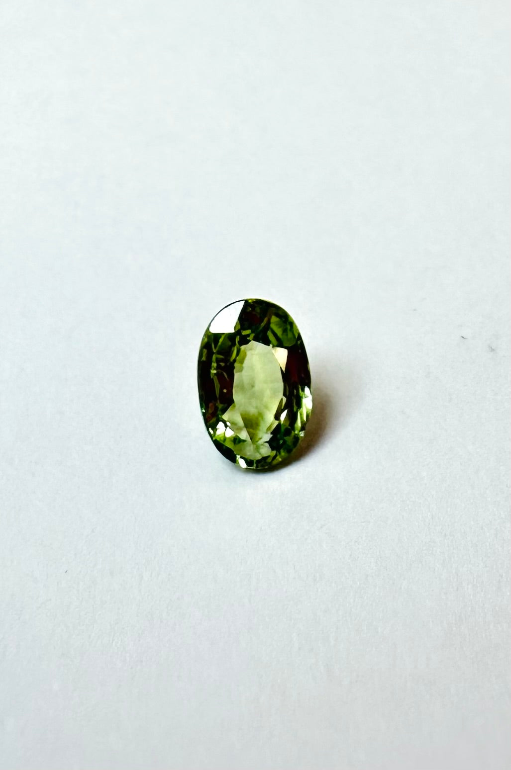 0.65cts 6.08x4.25mm Oval Faceted Green Sapphire