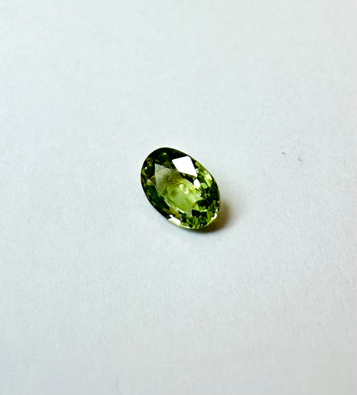 0.65cts 6.08x4.25mm Oval Faceted Green Sapphire
