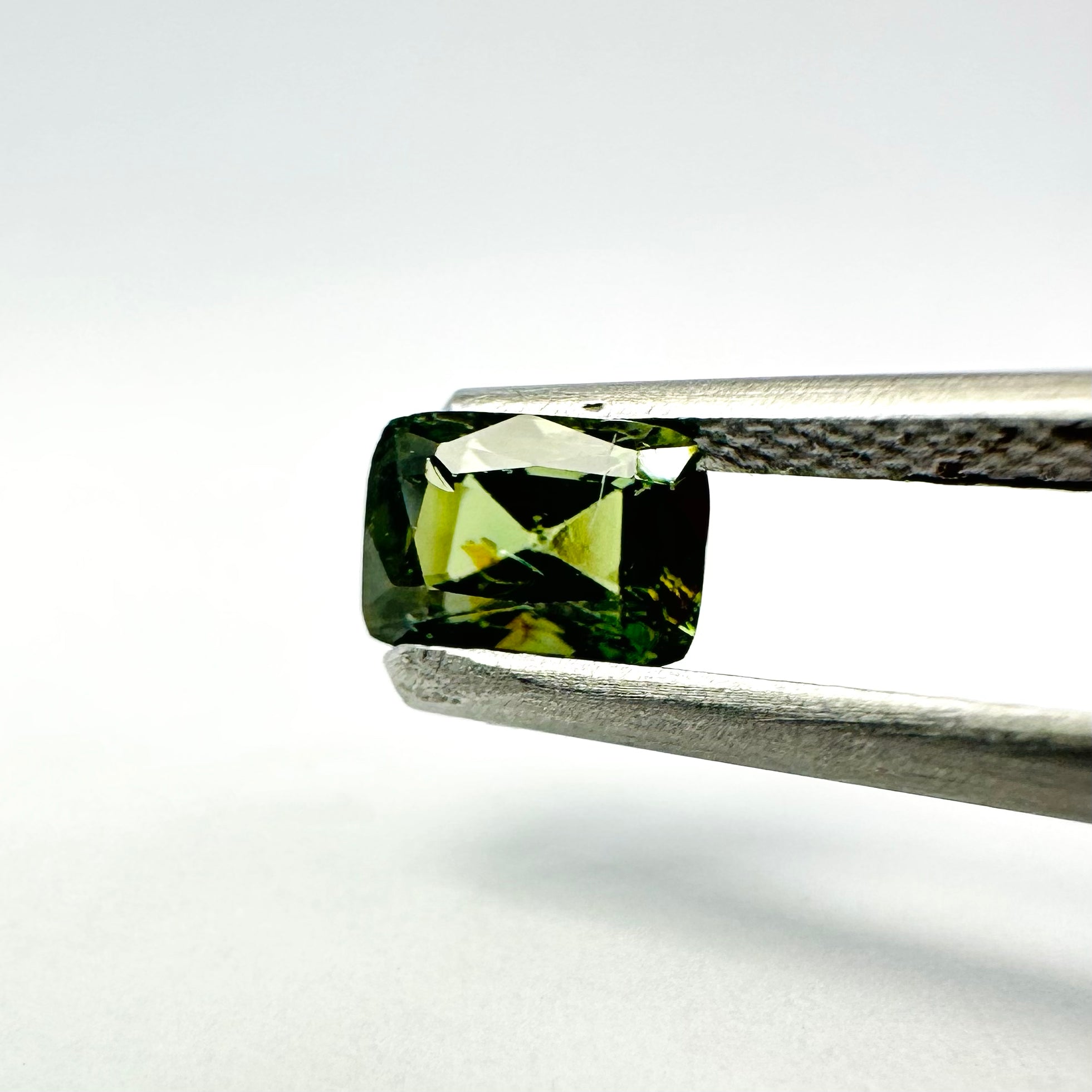 1.05cts 6x4.3mm Cushion Shaped Faceted Green Sapphire