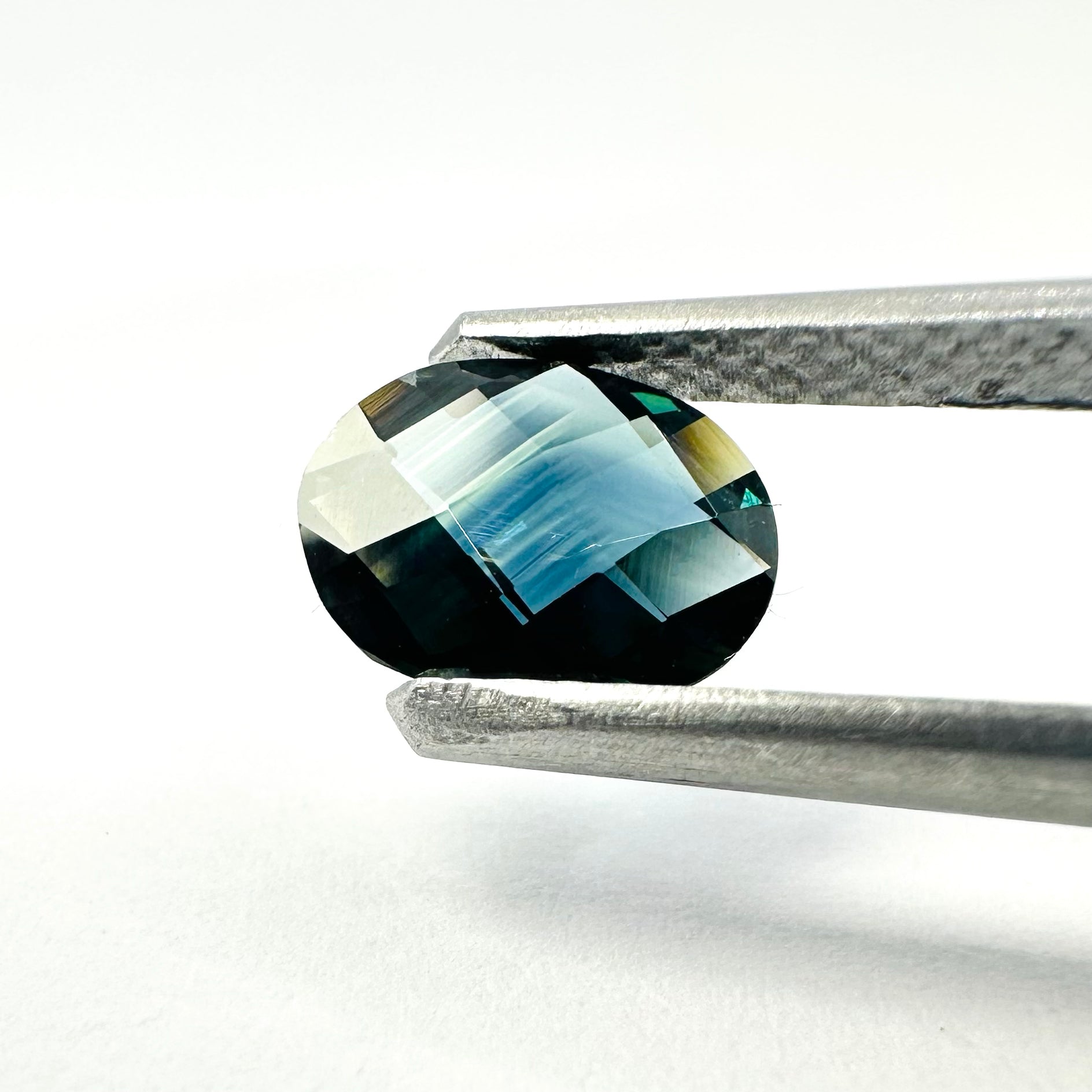 0.94cts 7.7x6mm Oval Checkerboard Cut Teal-Blue Sapphire