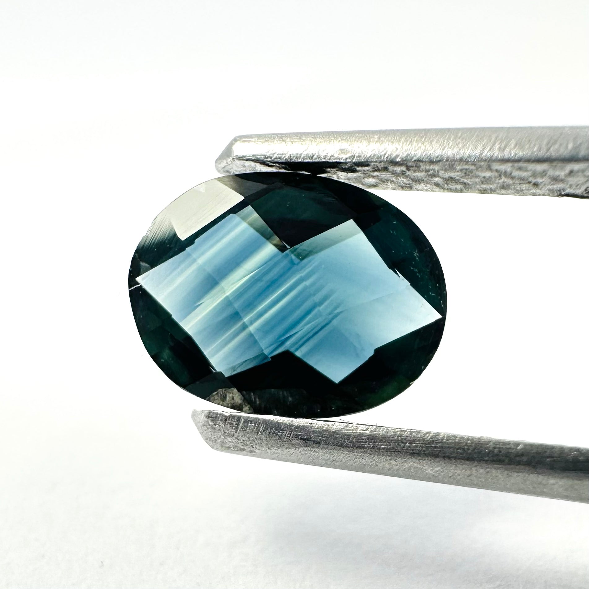 0.94cts 7.7x6mm Oval Checkerboard Cut Teal-Blue Sapphire